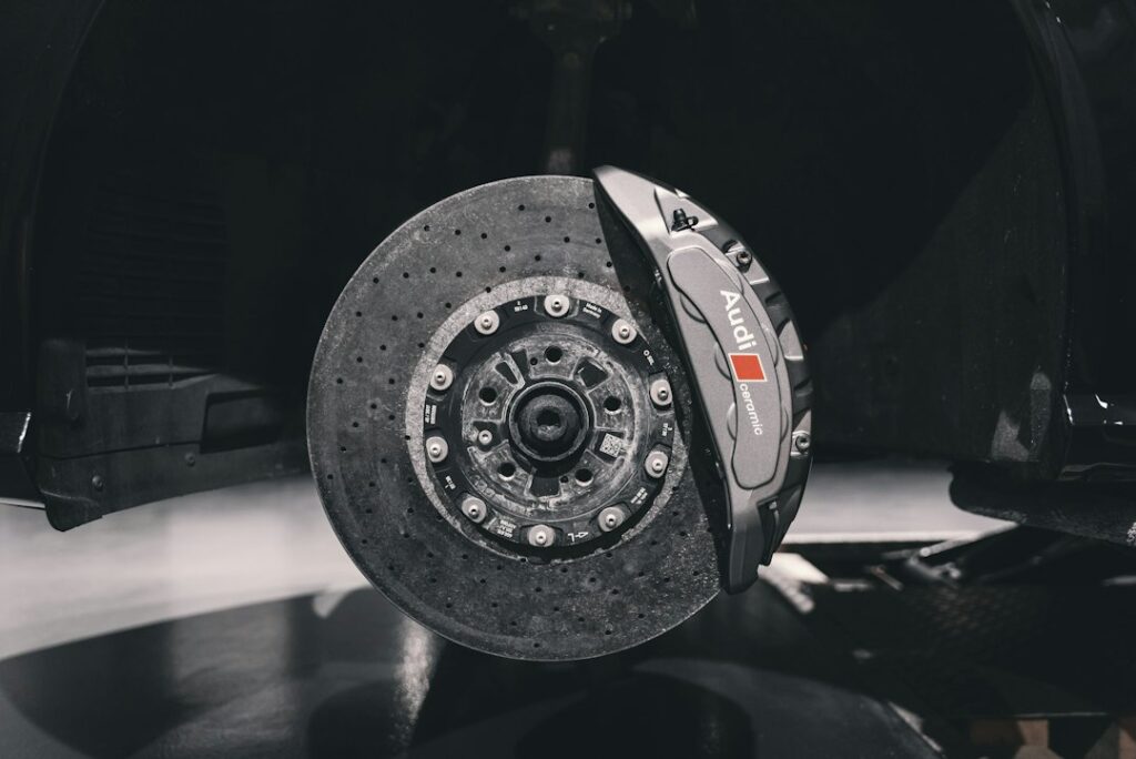 Car brake disc and caliper behind the wheel, where squeaking noises often start