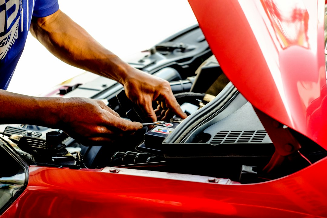 Person working on a car, checking the cause of a warning light
